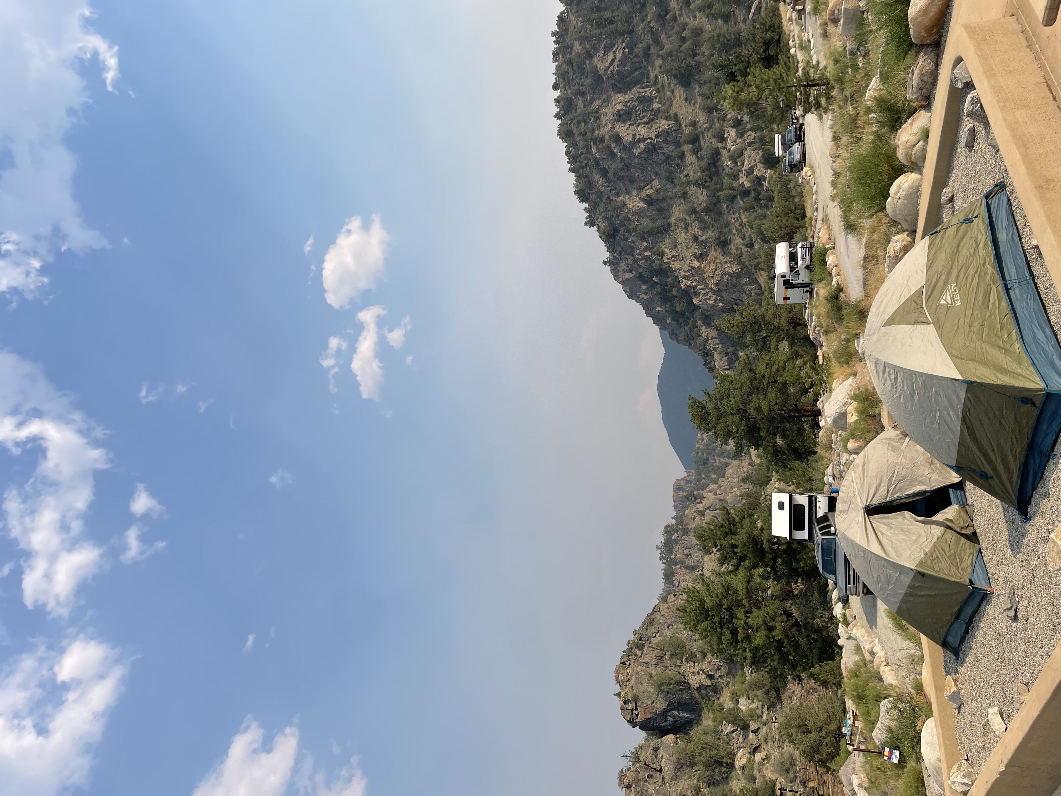 Two small tents in the foreground at a campsite. The background is the mountainous hills of the Arkansas river